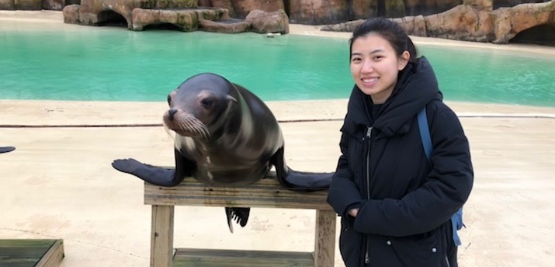 Student composer Jingyu Chen and a sea lion at Blackpool Zoo