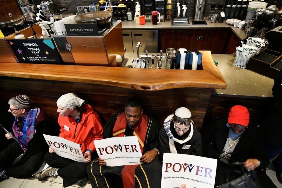 Anti-racism protestors sit in at the Starbucks where two black men were arrested. EPA-EFE/Bastiaan Slabbers