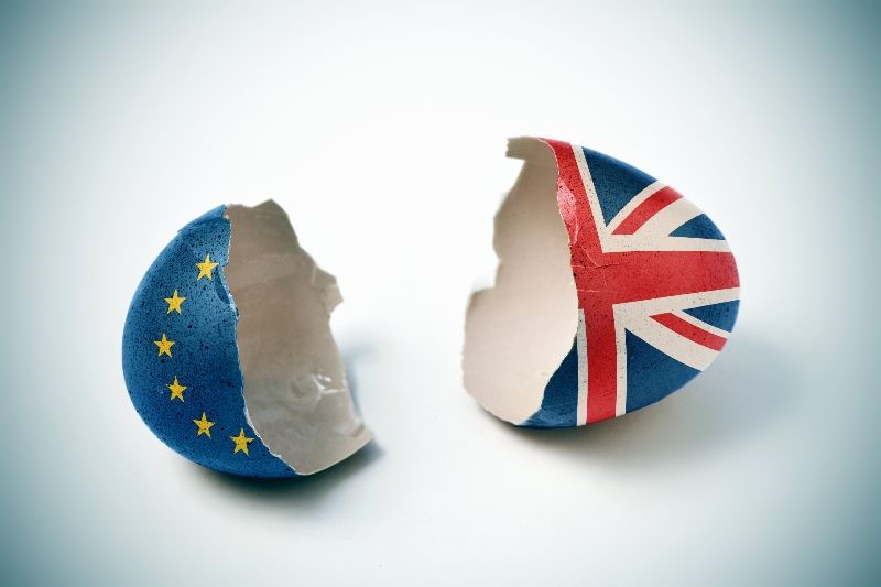Image of a broken eggshell, one half painted with EU flag, the other half with GB flag