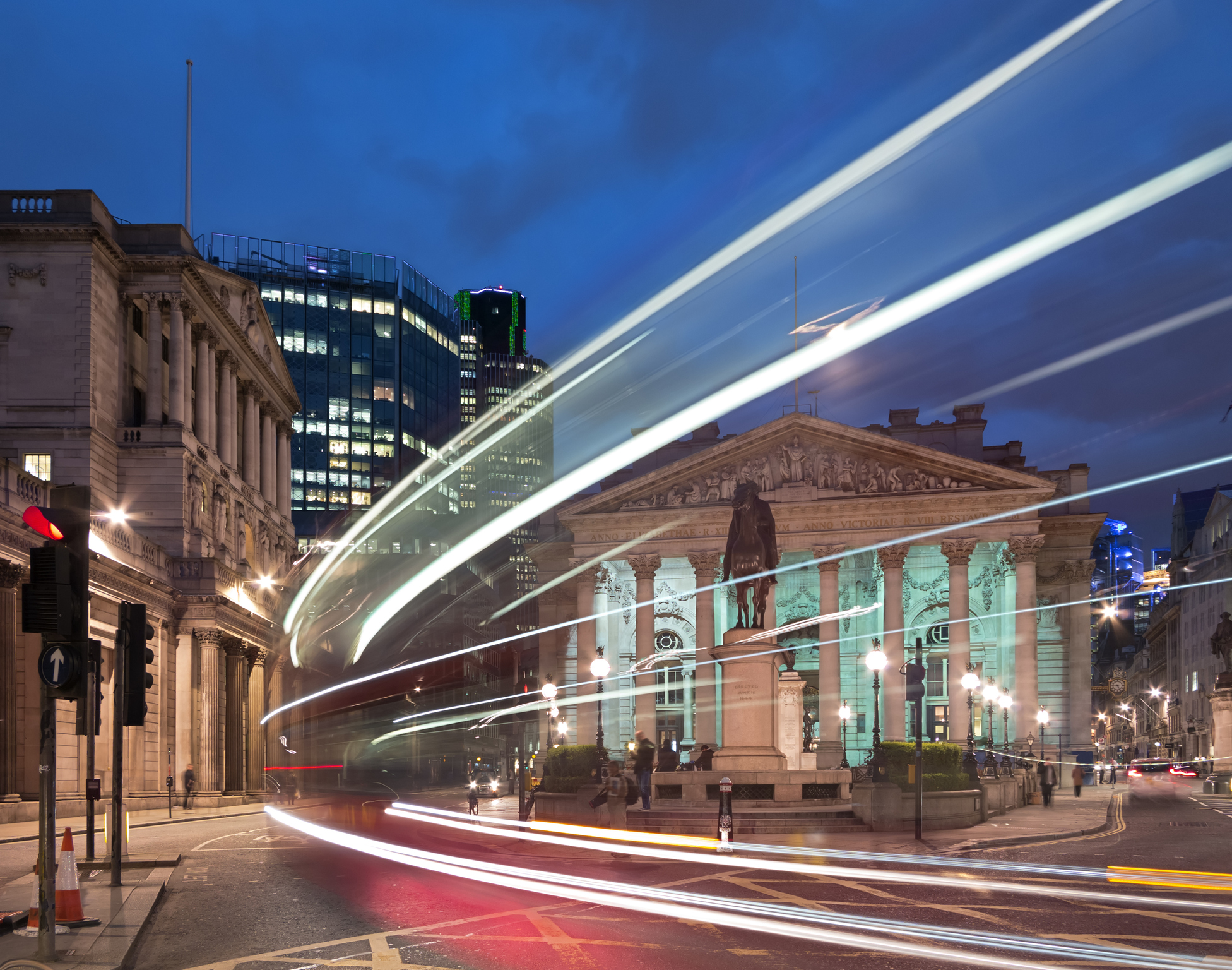 A bus going past the Bank of England at night