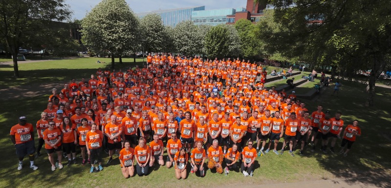 Team Orange pose for a group photo in All Saints Park prior to the start of the Great Manchester Run