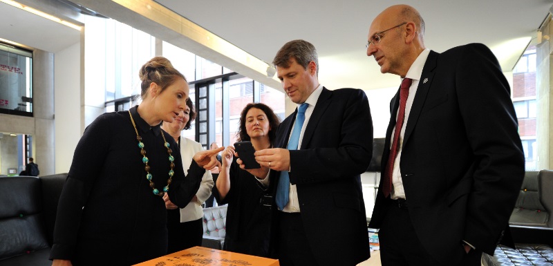 Universities Chris Skidmore MP, centre, tests out an augmented reality plinth during a visit to Manchester Metropolitan University accompanied by the University's Vice-Chancellor Professor Malcolm Press, right